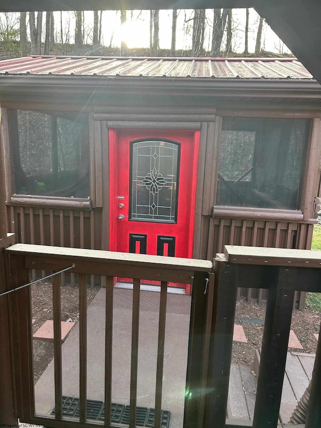 view of exterior entry featuring metal roof