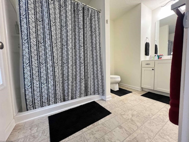 bathroom featuring a shower with shower curtain, baseboards, toilet, and vanity