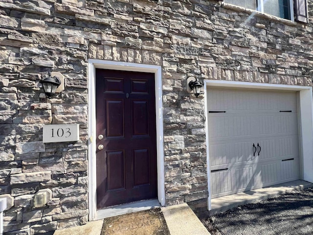 property entrance with stone siding