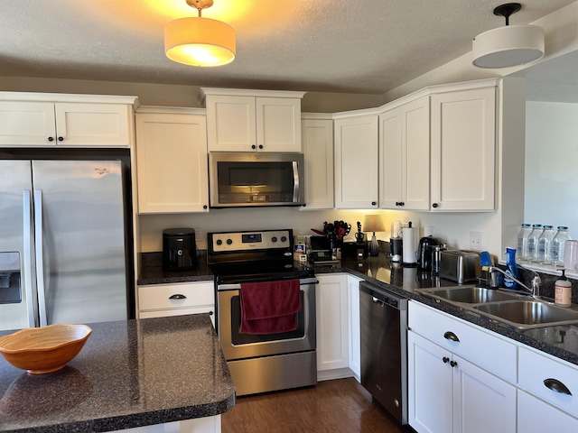 kitchen with a sink, stainless steel appliances, and white cabinets