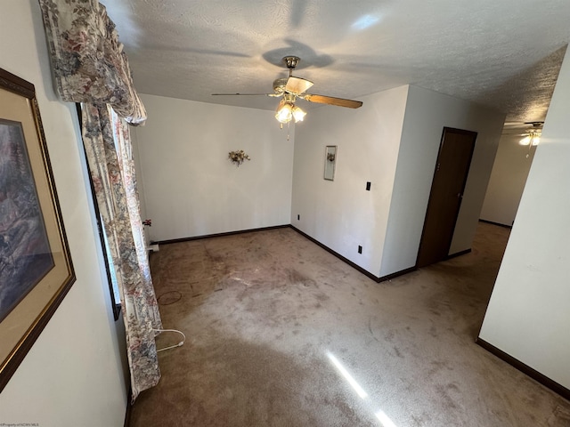 unfurnished room with carpet floors, a textured ceiling, and a ceiling fan