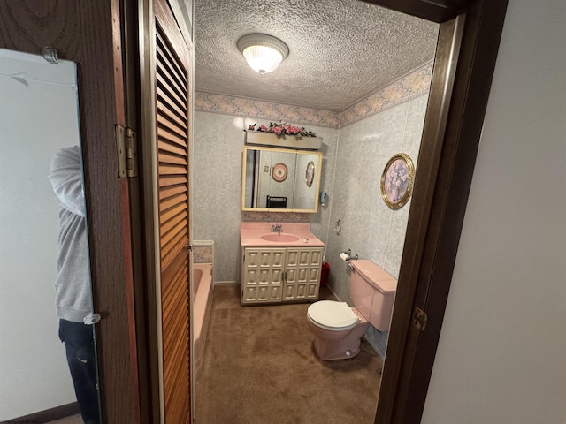 bathroom with toilet, a textured ceiling, and vanity