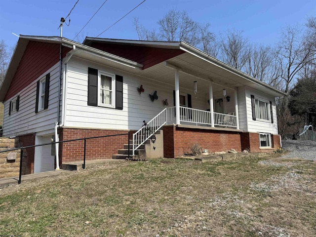 view of front of house with brick siding and covered porch