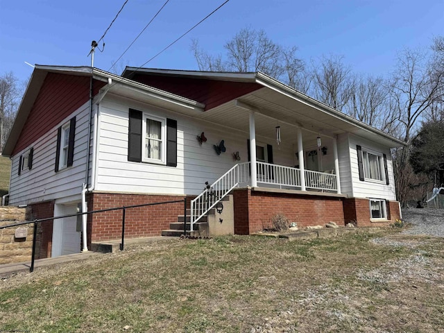 view of front of property featuring brick siding and a porch