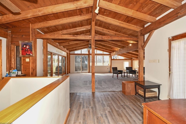 interior space with wooden ceiling, vaulted ceiling with beams, and wood finished floors