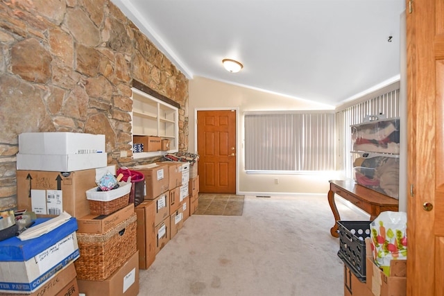 interior space featuring vaulted ceiling and carpet floors