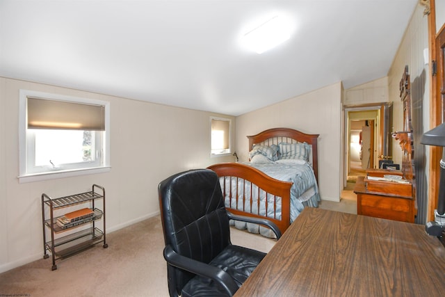 carpeted bedroom with vaulted ceiling and baseboards