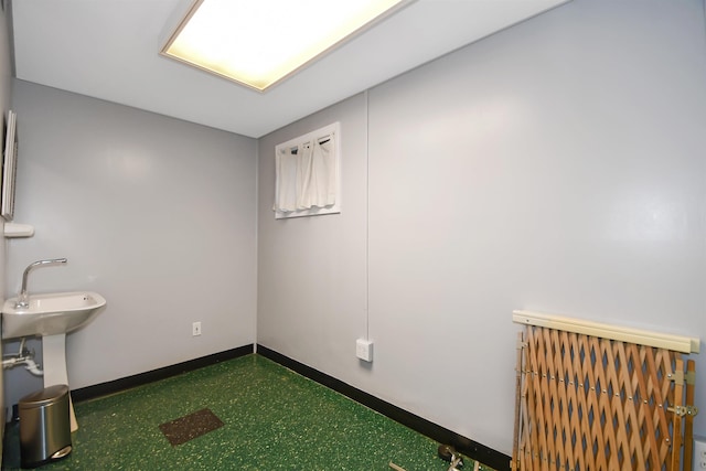 empty room featuring baseboards and golf simulator