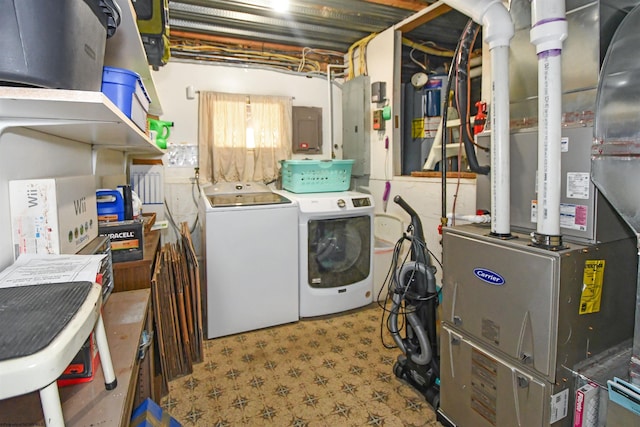 laundry room featuring washer and dryer, laundry area, electric panel, and tile patterned floors