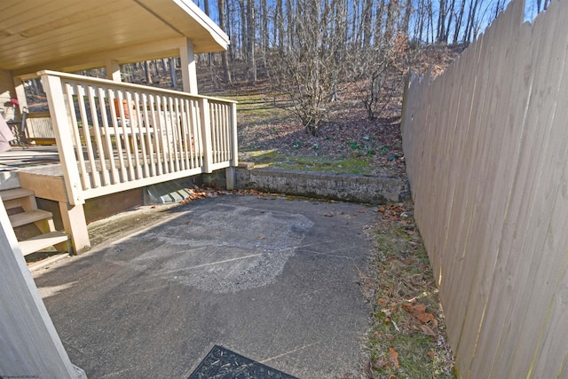 view of gate with a deck and fence