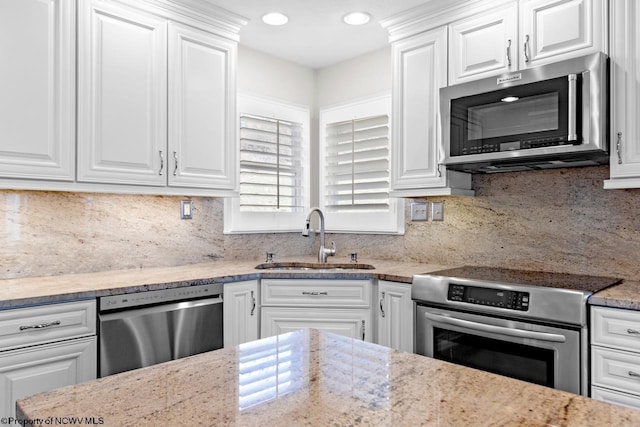 kitchen featuring a sink, white cabinets, and stainless steel appliances