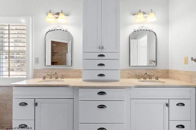 full bath with double vanity and a sink