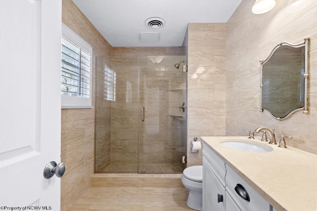 full bathroom featuring visible vents, toilet, tile walls, and a shower stall