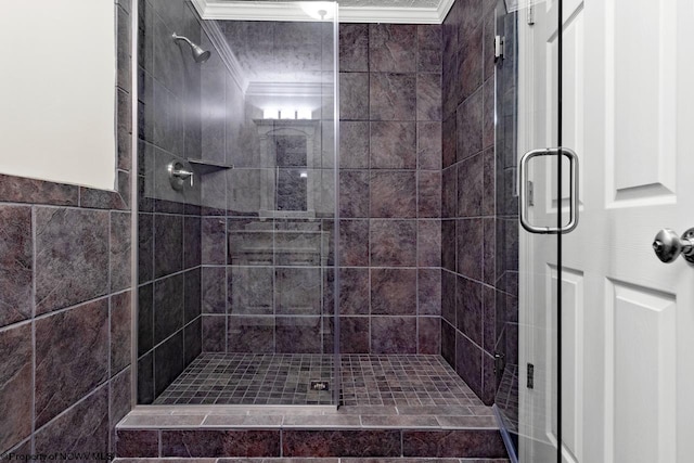 bathroom with a stall shower and ornamental molding