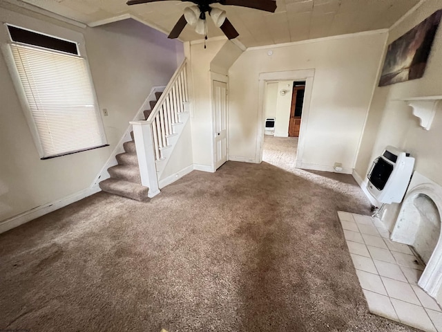 unfurnished living room featuring heating unit, carpet floors, crown molding, ceiling fan, and stairs