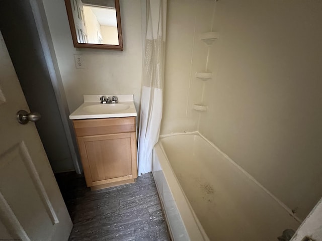 bathroom with vanity, wood finished floors, and shower / tub combo with curtain