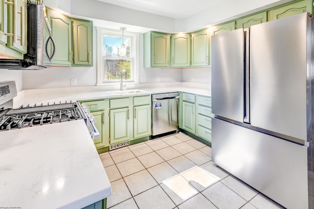 kitchen featuring green cabinetry, appliances with stainless steel finishes, and a sink