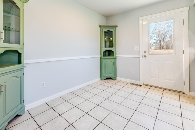 entryway with visible vents, baseboards, and light tile patterned flooring