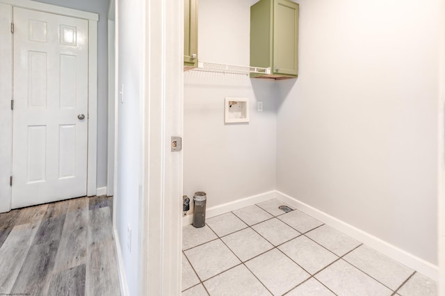 laundry area featuring baseboards, cabinet space, and hookup for a washing machine