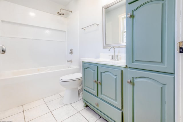 bathroom featuring vanity, tile patterned floors, toilet, and washtub / shower combination