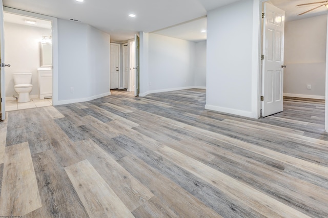 basement featuring recessed lighting, visible vents, baseboards, and wood finished floors