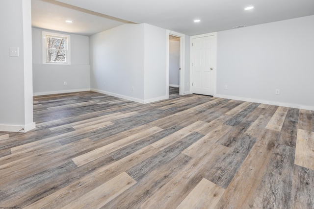 unfurnished room featuring recessed lighting, visible vents, baseboards, and wood finished floors