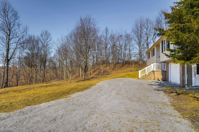 view of road with gravel driveway