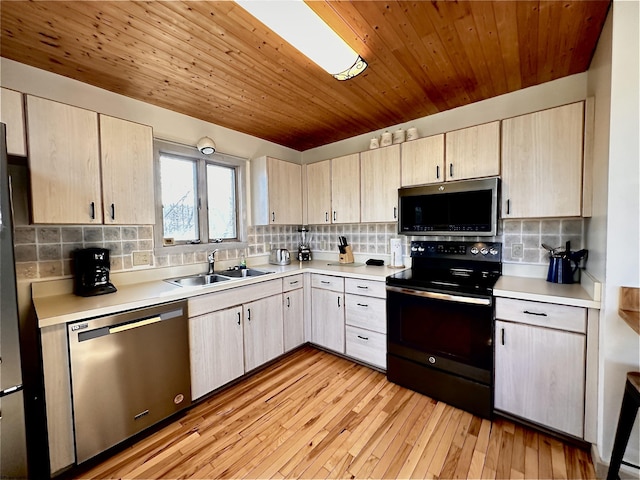 kitchen with light wood-type flooring, light brown cabinetry, a sink, stainless steel appliances, and light countertops