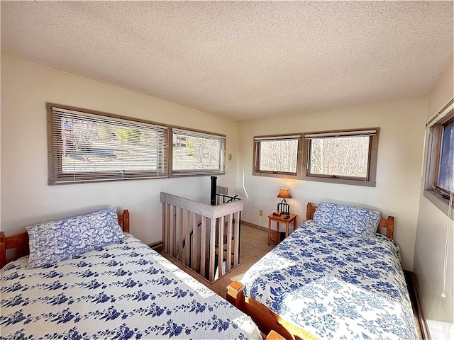 bedroom featuring carpet and a textured ceiling