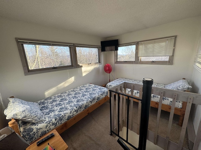 carpeted bedroom featuring a textured ceiling