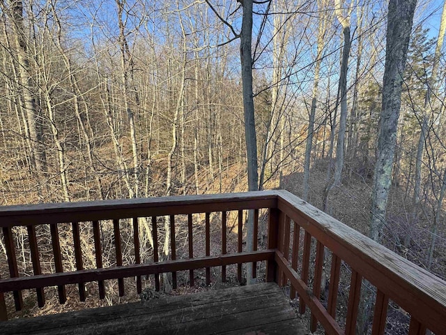 wooden deck featuring a view of trees