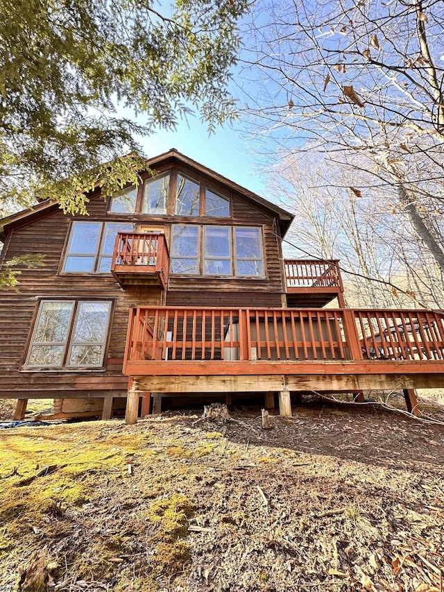 back of property with a wooden deck