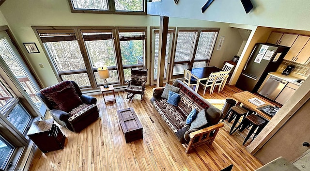 living room featuring a high ceiling and light wood finished floors