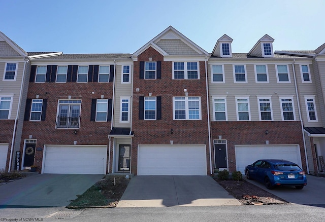 townhome / multi-family property featuring brick siding, driveway, and an attached garage