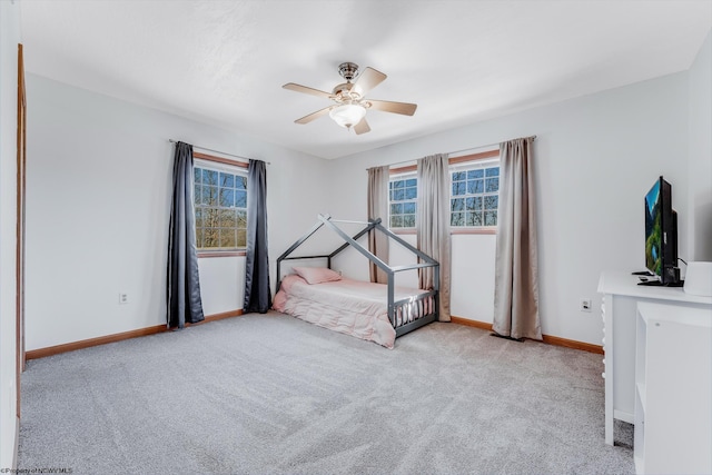 carpeted bedroom featuring ceiling fan and baseboards