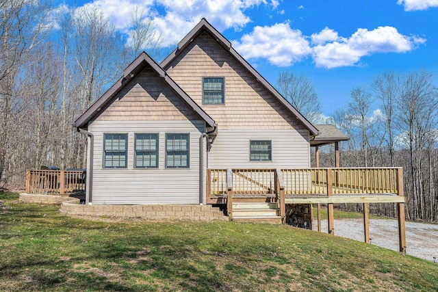 back of house featuring a lawn and a deck