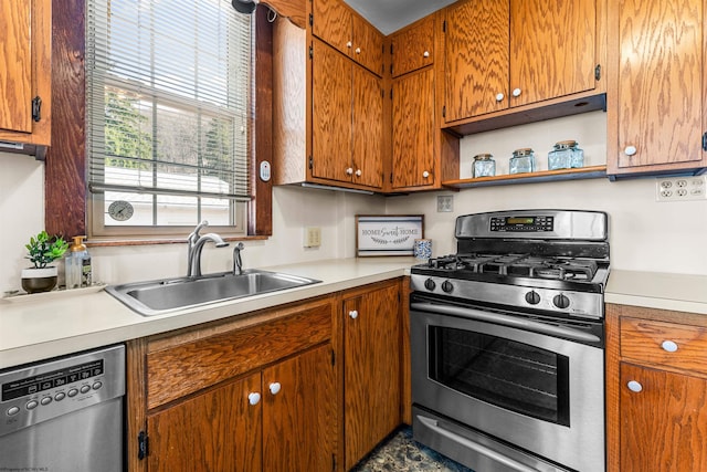 kitchen with light countertops, brown cabinets, appliances with stainless steel finishes, and a sink