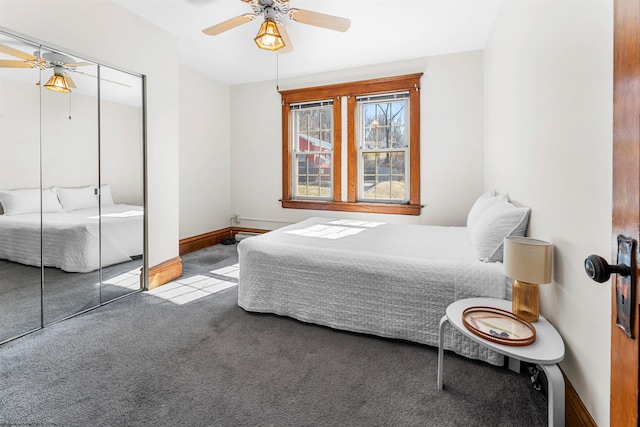 bedroom with a closet, baseboards, carpet floors, and ceiling fan