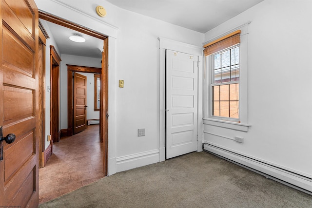 unfurnished bedroom with a baseboard heating unit, baseboards, carpet, and a baseboard radiator