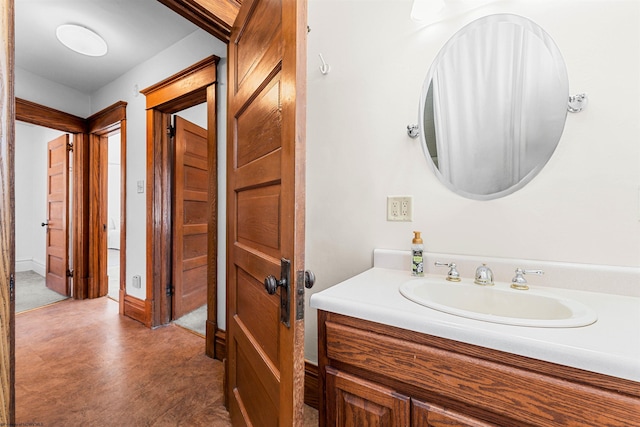 bathroom with vanity and baseboards