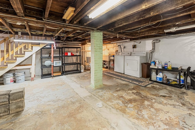 unfinished below grade area featuring independent washer and dryer and stairs