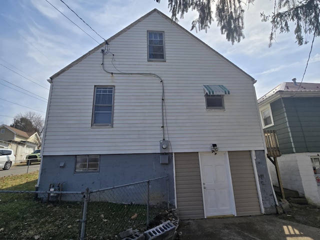 rear view of property featuring fence