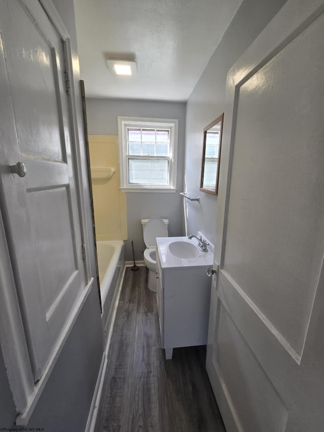 bathroom with toilet, wood finished floors, and vanity