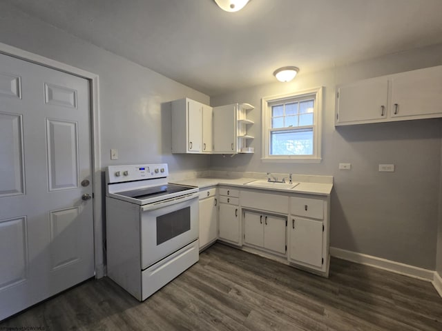 kitchen featuring electric range, white cabinetry, light countertops, and a sink