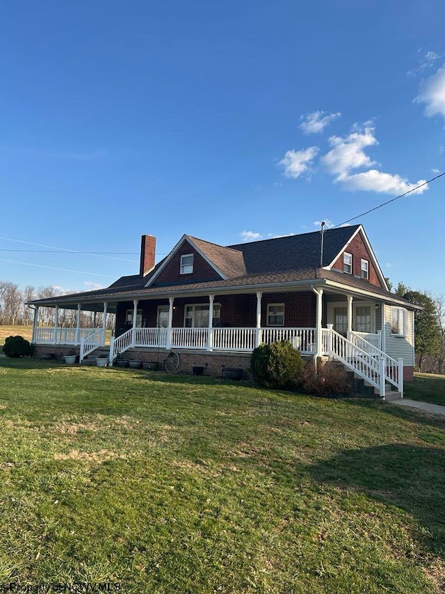 view of front of house with a front lawn, covered porch, and a chimney