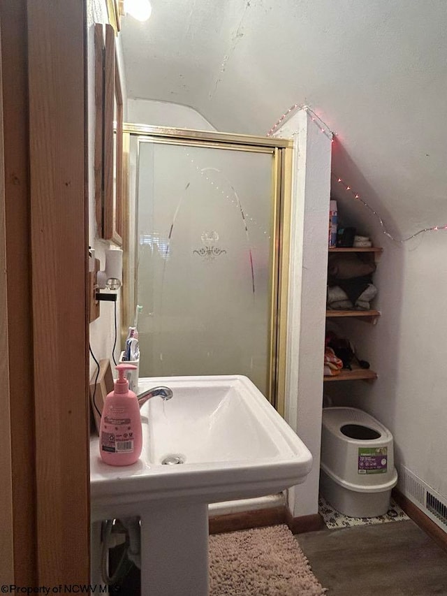 bathroom featuring baseboards and a stall shower