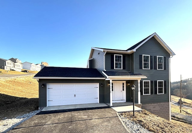 traditional-style home featuring driveway and a garage