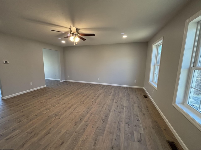 unfurnished room with baseboards and visible vents