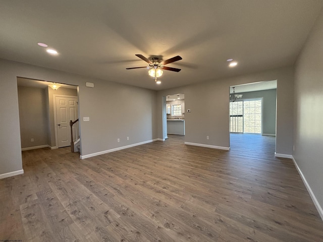 interior space with baseboards, ceiling fan, and wood finished floors