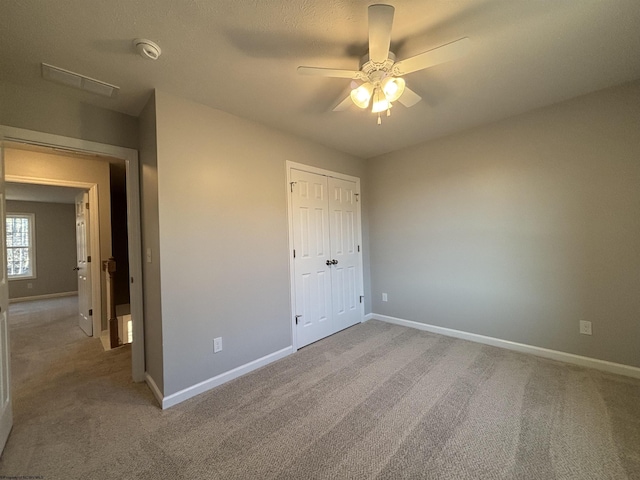 unfurnished bedroom featuring a closet, baseboards, and carpet